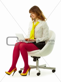 Girl in a bright dress with a laptop