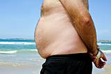 Fat man on the beach