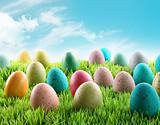 Colorful Easter eggs in a field of grass