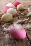 Colorful easter eggs with feathers on old table