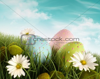 Decorated easter eggs in the grass with daisies 
