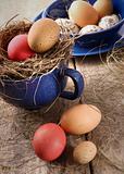 Easter eggs in blue enamel cup with straw