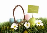 Easter eggs with  basket in the grass
