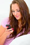 Smiling beautiful woman typing text sms message on her mobile
