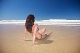 sexy woman sitting in water at Conil beach