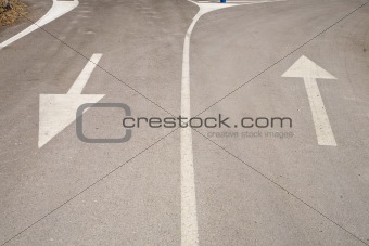 two arrows on asphalt