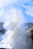giant wave crashing on cliffs