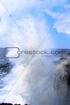 giant wave crashing on cliffs