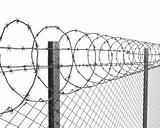 Chainlink fence with barbed wire on top closeup