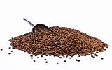 Metal scoop partially burried in coffee beans heap