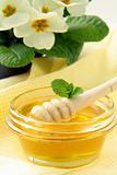 fresh golden honey in jar  with a wooden spoon