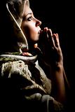Portrait of beautiful praying girl with old russian shawl on head. Retouched
