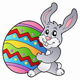 Cartoon bunny holding Easter egg