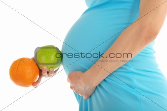 Pregnant woman's belly, apple and orange