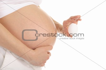 pregnant woman holding an egg