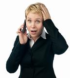 young business woman shocked by phone talk