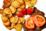 Beef steak with sliced potatoes and strawberries