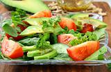 salad with tomato and avocado on a crystal  plate