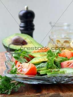 salad with tomato and avocado on a crystal plate
