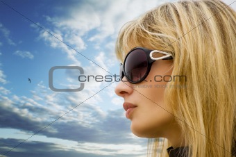 young blond girl on the sky