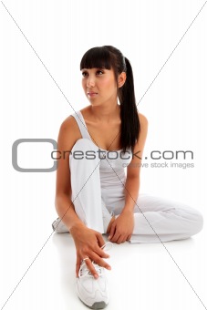 Young woman sitting wearing fitness exercise clothing.
