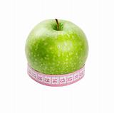 Green apple and measuring tape of the tailor isolated on white