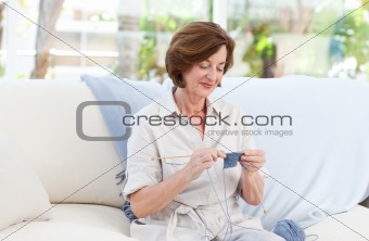 Woman knitting at home