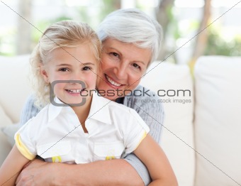 Lovely little girl with her grandmother looking at the camera