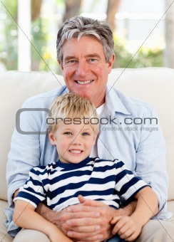 Little boy with his grandfather looking at the camera