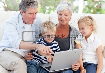 Adorable family looking at their laptop