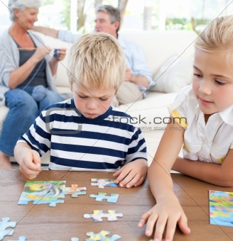 Children playing puzzle in the living room