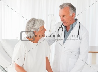 Doctor helping his patient to walk