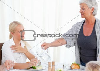 Aged woman serving her daughter