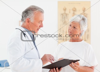 Senior doctor talking with his sick patient