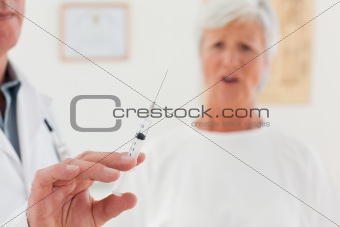 Senior doctor with syringes