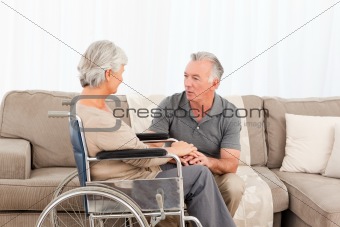 Man with his wife in a wheelchair