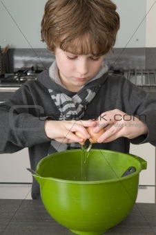 Boy making the dough for the cakes