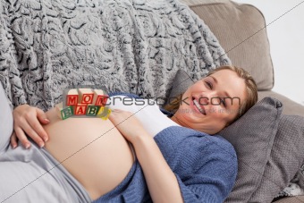 Pregnant young woman with cubes on her belly