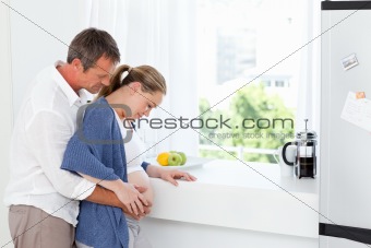 Couple hugging in the kitchen