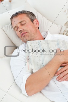 Exhausted man sleeping on the couch at home