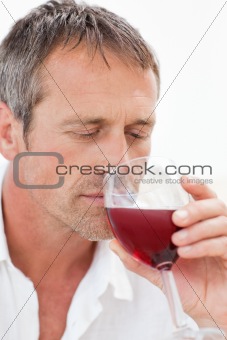 Handsome man drinking some red wine 