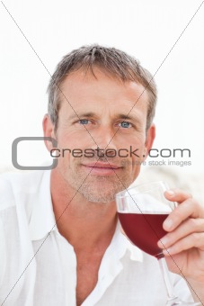 Handsome man drinking some red wine 