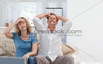 Lovers watching tv in the living room at home