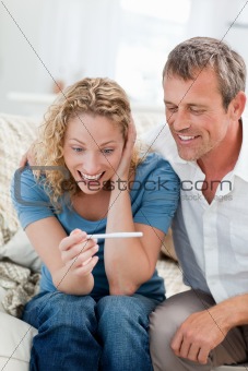 Lovers looking at a pregnancy test 