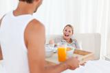 Man bringing the breakfast to his wife