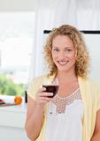 Woman looking at the camera with her drink of wine