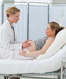 Nurse reassuring her pregnant patient