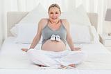 Pregnant woman with baby shoes on her belly