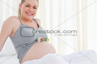 Pregnant woman with baby cubes on her belly