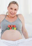 Pregnant woman with baby cubes on her belly
